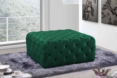 a large green ottoman sitting on top of a rug