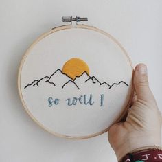 someone is holding up a hand embroidered wall hanging with the words, so you'll