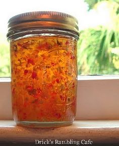 a jar filled with liquid sitting on top of a window sill