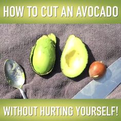 an avocado cut in half on top of a towel next to a knife