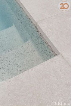 an empty swimming pool with no people around it and the water is blue in color