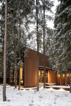 a cabin in the woods surrounded by snow