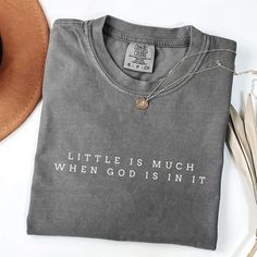 Shop for other awesome stuff: https://athreadoffaithco.etsy.com Little is Much T-Shirt Celebrate the power of faith with our Comfort Colors t-shirt featuring the simple yet profound message: "Little is Much When God is in It." Designed in a minimalistic font for a clean and timeless look. Details: Material: 100% ring-spun cotton Feel: Soft-washed, garment-dyed for extra coziness Fit: Relaxed, unisex sizing (size up for an oversized fit) Design: Minimalistic font with a powerful faith message Shi Cute Christian Tshirts, Christian Tshirt Design Ideas, Bible Verse Shirts, Bible Verse Inspirational, Christian Shirts For Women, Bible Verse Tees, Bible Shirts, Gift Idea For Women