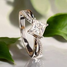 a ring with a princess cut diamond on it