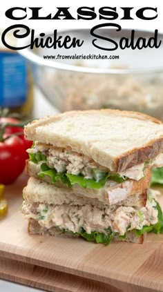 a chicken salad sandwich cut in half on a cutting board