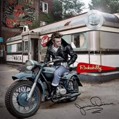 a man sitting on top of a motorcycle in front of a building with a coca cola sign