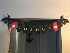 a decorated mirror in the corner of a room with black and red decorations on it