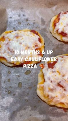 four small pizzas sitting on top of a pan covered in cheese and sauce with the words 10 months & up easy cauliflower pizza