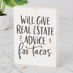 a wooden sign that says will give real estate advice for tacos on the table