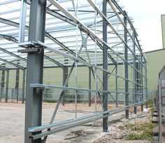 the inside of a building that is being constructed with metal beams and steel bars on each side