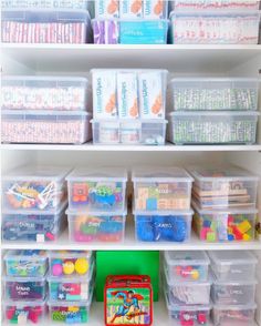 the shelves are filled with many different types of plastic containers and bins for storage