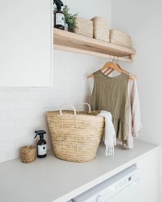 a laundry room with white walls and open shelving