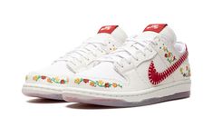 the nike air force 1 low is decorated with flowers and leaves on white canvas shoes