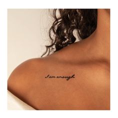 the back of a woman's shoulder with an inscription on it that says i am enough