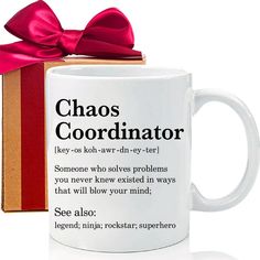 a white coffee mug with a red bow on it next to a box that says chaos coordinating