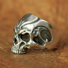 "It's a hard way to the top if you wanna rock and roll" ac/dc ! this silver skull ring will take you to the top, my friend! Are you a fan of rock? Like to listen or play to rock? Then these sterling silver rock rings is made for you. With this masterpiece on your finger, you can be sure that you will feel the power and the spirit of the greatest rockers ever through your veins. As you may have noticed, this skeleton head is well detailed with beautiful engravings all over the forehead, the sharp Adjustable Silver Skull Ring Punk Style, Adjustable Silver Skull Ring In Punk Style, Edgy Silver Skull Ring As Gift, Edgy Silver Skull Ring For Gift, Punk Style Skull Ring For Halloween Collectible, Silver Skull Ring For Halloween Streetwear, Silver Edgy Skull Ring For Halloween, Silver Skull Ring For Biker Events And Halloween, Silver Skull Ring For Halloween