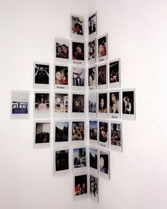 a cross made out of photos is hanging on the wall in front of a white wall