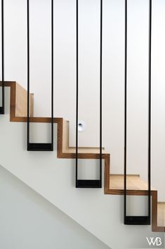 an image of a stair case going up the side of a staircase with wood and metal handrails