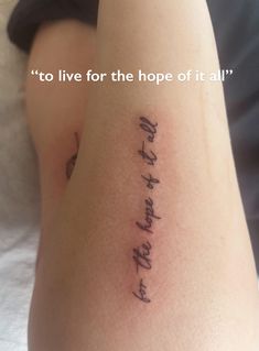 a woman with a tattoo on her arm saying to live for the hope of it all