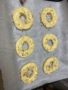 six doughnuts are on a baking sheet and ready to go into the oven