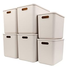 six white storage bins stacked on top of each other