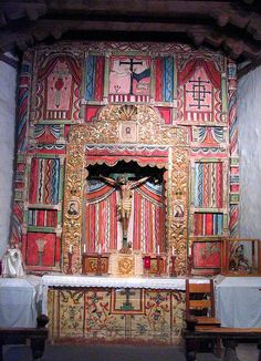 the altar is decorated with colorfully painted wood