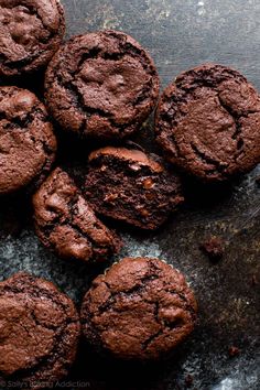 chocolate cookies on a table with one broken in half