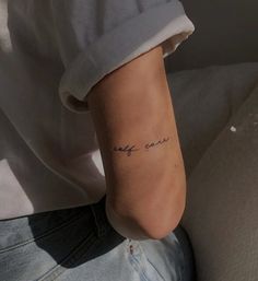 a person with a small tattoo on their left foot and the word love is written in cursive writing