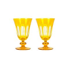 two yellow glass goblets sitting next to each other