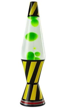 a glass vase with green and black designs on it's sides, sitting in front of a white background