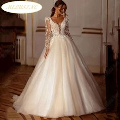 a woman in a wedding dress standing on the floor