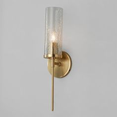 a wall light with a glass shade on it