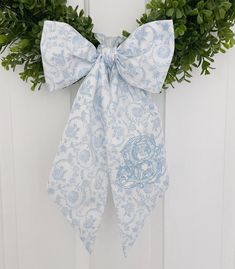 "This beautiful blue floral fabric is perfect for spring! Please include the thread color, font and initial you would like embroidered. Measures approximately 68\"x4.5\". a pictured is the antique font. The first photo is light blue and the darker blue is hydrangea. If a color or font isn't chosen, we will match the main photo. These are completely sewn by me, which means the embroidery will not be shown through on the other side.  Need a custom one? Send a message and we can help you come up wi Dusty Blue Home Decor, Blue Hydrangea Decor, Blue Green Wedding Colors, Light Blue Home Decor, Blue Floral Linen Wedding, Wreath Sash Monogram, Blue Toile Baby Shower Decor, Antique Font, Wreath With Monogram Sash