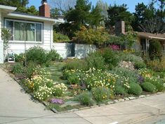 a house with lots of flowers in the front yard