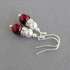 To create these burgundy pearl drop earrings, I have paired dark red and white glass pearls and sparkling crystal bands. These pearl dangle earrings would add a touch of sparkle to a claret themed wedding. Each wine coloured teardrop earring measures 2.4cm / 1 inch from the bottom of the ear hook and measures 8mm wide at the widest point. All fittings used are Sterling silver. All of my ear hooks are sold with plastic stoppers to ensure they stay firmly in your ears. Your marsala beaded jeweller Elegant Red Pearl Earrings For Parties, Red Pearl Drop Earrings For Wedding, Red Pearl Earrings For Wedding, Elegant Red Pearl Earrings For Anniversary, Red Pearl Drop Earrings For Formal Occasions, Red Pearl Drop Earrings For Party, Red Dangle Pearl Earrings For Party, Elegant Burgundy Jewelry For Party, Elegant Burgundy Party Jewelry