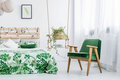 a bedroom with white walls, green bedding and hanging planters on the wall