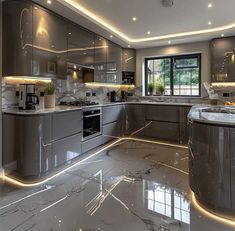 a large kitchen with marble counter tops and gray cabinets, along with lights on the ceiling