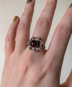 Vintage Sterling Silver Sun Flower Statement Ring. Has a purple/reddish colour stone. So stunning and such a special piece. Would make a good gift. Really pretty and unique  UK Size - N  Condition is as seen Antique Rings Victorian Silver, Garnet Ruby Ring Gift, Vintage Flower Gemstone Jewelry, Vintage Flower-shaped Gemstone Jewelry, Garnet Ruby Ring As Birthstone Gift, Ruby Ring As Birthstone Gift, Vintage Sterling Silver Flower Ring Gift, Red Sterling Silver Flower Ring For Anniversary, Vintage Jewelry With Round Stone For Gift