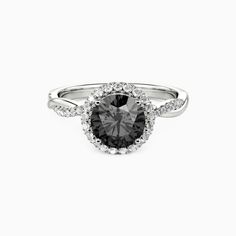 a black and white diamond ring with diamonds around the shans on it's sides