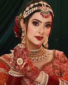 a woman wearing red and gold jewelry