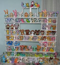 a shelf filled with lots of littlest pet toys