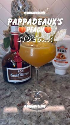 an orange drink sitting on top of a counter