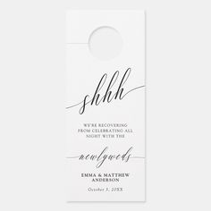 a white door hanger with the word shhl on it and an elegant calligraphy font