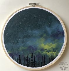 a cross - stitch pattern with trees and stars in the night sky