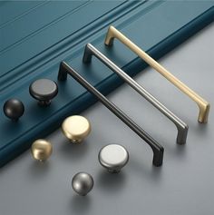 various door handles and knobs on a gray surface with the words kak above them