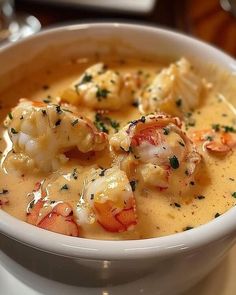 a white bowl filled with shrimp and cheese soup