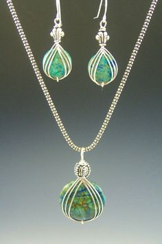 a necklace and earring set with turquoise glass beads on a silver plated chain