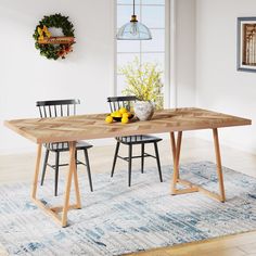 a dining table with two chairs and fruit on it in front of a large window