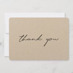 a thank card with the word thank you written in black ink on top of it