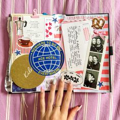 a person's hand is on top of an open book with pictures and letters